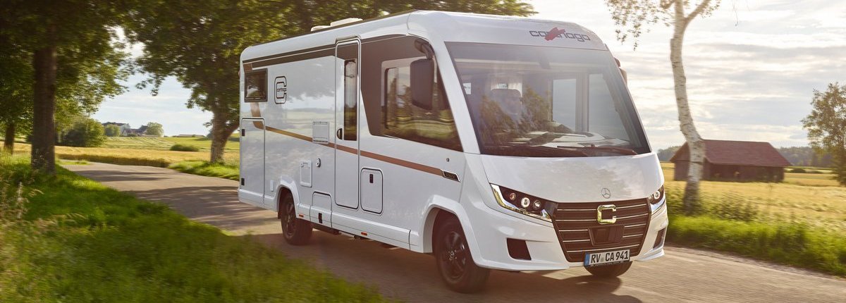 Carthago Wohnmobil C2-tourer auf der Straße, vorbei an Bäumen