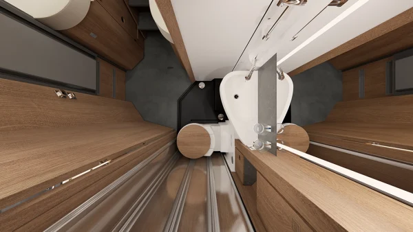 Draufsicht auf ein kompaktes, modernes Wohnmobil-Badezimmer im Carthago c2-Tourer mit Holzverkleidung, einem kleinen weißen Waschbecken, einer Toilette, Metallschienen auf dem Boden und einer Schiebetür – ein Beispiel für die effiziente Nutzung des begrenzten Platzangebots in diesem Modell.