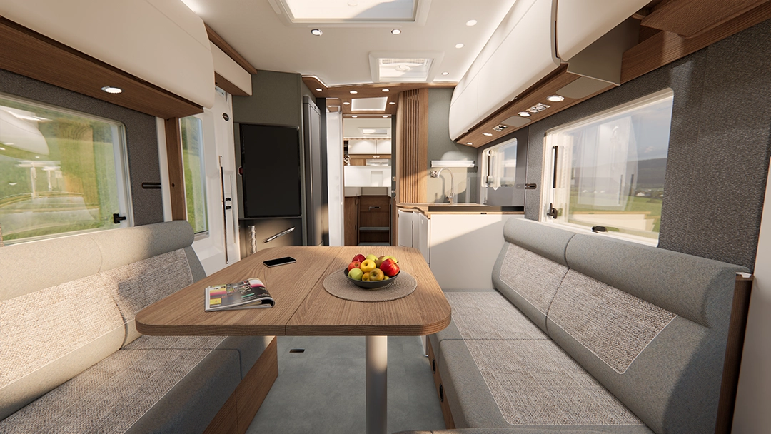 Moderne Wohnmobil-Innenausstattung mit einem Esstisch, gepolsterten Sitzbänken, einer Obstschale und einer Zeitschrift. Inspiriert vom eleganten Design des Carthago C2-Tourer besticht der Raum durch Holzakzente, große Fenster und einen Küchenbereich im Hintergrund.